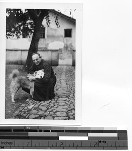 Father Downs with his dog in Meixien, China, 1935