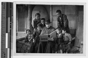 Father Carroll reads to group of Korean children, Anshu, Korea, ca. 1930-1939