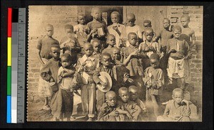 Children standing outdoors and holding prizes, Congo, ca.1920-1940