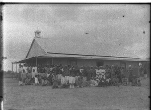 Group of African people in front of a chapel, Catembe, Mozambique, ca. 1901-1907