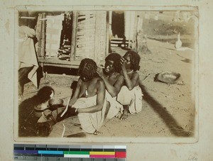 Three Malagasy women taking lice out of each others hair, Madagascar, ca.1900