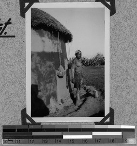 Tembu girl plastering the house, South Africa East