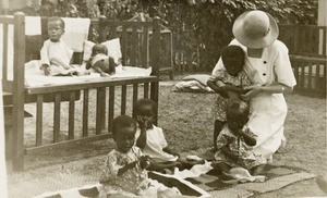 Female missionary with babies, ca. 1930