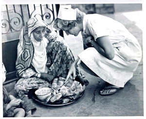 Nurse Signe Jung examines the food which has been prepared by relatives to a patient