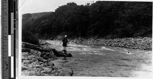 Japanese man fishing in a river, Japan, ca. 1920-1940