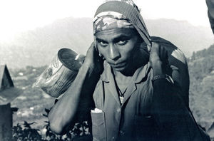 Nepal. Tansen, Palpa, October 1991. Woman carrying loads in a basket on her back (dhoka)