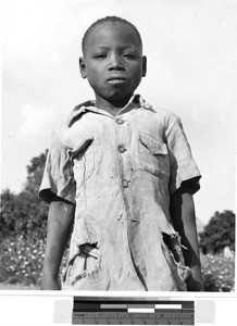 Close-up view of a boy standing outside, Africa, October 1950