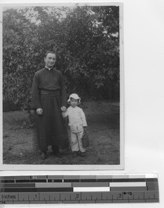 Fr. Burke with a child at Yangjiang, China, 1931