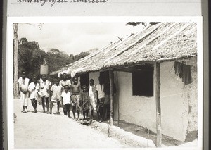 A dormitory for boys in the bush-style (clay walls and a roof out of mats) with several children suffering from leprosy