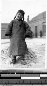 Orphan girl dressed for winter, Fushun, China, 1934