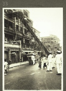 Chinese funeral in Kowloon. Photograph by Rev. Weickum, Fopin. The coffin is carried down out of the house on a scaffolding specially built for the occasion, so that the spirit of the deceased cannot find its way back. In this photograph the mourners are coming down the staircase