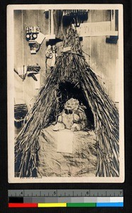 Fetish in grass hut on display, Benin, ca.1925