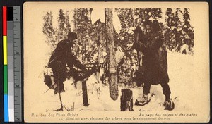 Missionary fathers cutting down a tree in a snowy forest, Canada, ca.1920-1940