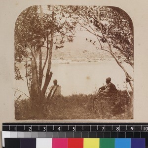 Two men seated on bank of River Mangoro, Madagascar, ca. 1865-1885