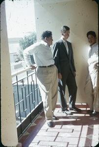 Three men on balcony