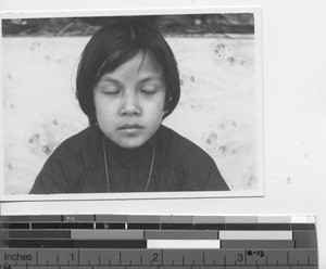 A young girl prays at Guangzhou, China, 1938