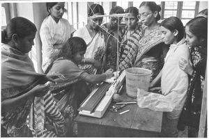 South India, 1977. The Sewing School at Tiruvannamalai. Women working with the knitting machine