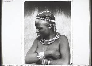 Mbembe girl, a non-christian. The many brass rings on her arm, the chains around her neck, and her headdress, are her pride. She does not yet know that a pure heart and a joyful spirit are the most beautiful things we humans can possess