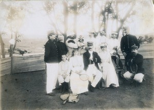 Men and women with tennis rackets and a monkey, in Madagascar