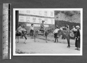 Men on donkeys preparing for trip, Tibet, China, ca.1945-1946