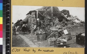 Missionary travelling through village, Yunnan, China. ca. 1920