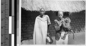 Two men and a monkey, Africa, October 1947