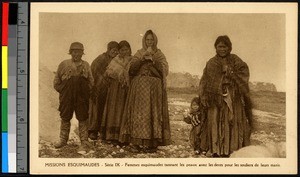 Women preparing hides outdoors on a stony field, Canada, ca.1920-1940