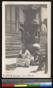 Buddhist monk sitting in a temple courtyard, Jiangsu, China, ca.1905