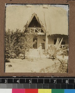 Missionary's wife on mission house steps, Kambole Mission, Zambia, ca. 1925