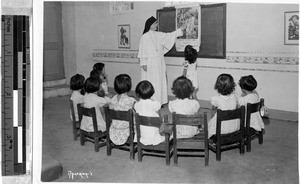 Maryknoll Sister Clotilde teaching a kindergarten class at Catholic school in Lucena, Philippines, 1947