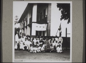 A part of the primary school in Kutschuk. (In the centre the mission station's elders, in the foreground the school band, which every school simply has to have, and behind the obligatory flags)