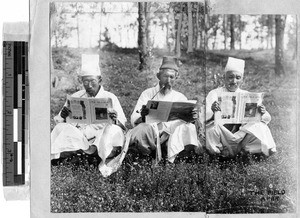 Three men reading The Field Afar, Hiken, Korea, 1929