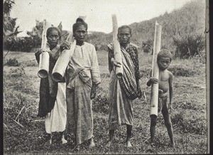 Natives of British North Borneo, carrying water