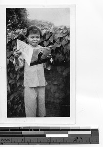 An orphan reading at Luoding, China, 1937