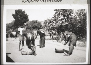 Baptismal candidates bind up rice