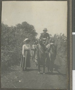 Dr J N Ogilvie carried to school, Central province, Kenya, September 1920