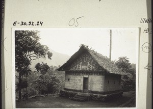 A small church in Mendig (Minge district) with a cross and a chief's stool