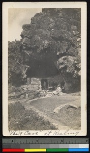 Man standing in the doorway of a walled-in cave, China, ca.1910-1915