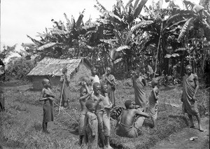 Children and men in front of banana plants, Tanzania, ca.1893-1920