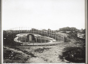 A newly-built grave, surrounded by a light fence to protect it from the water buffalo