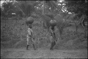 African women coming back home with water provision for the day