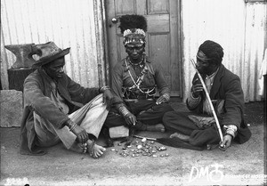 African man casting bones for divination, Pretoria, South Africa, ca. 1896-1911