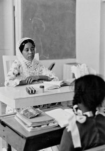 An arabian female teacher is teaching in the Mission School in Oman, 1975