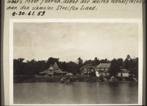 Sampit, where people pause in their journeys. You see the mosque, and on the right with its high entrance arch the Koran School