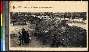 People standing near thatch-roofed huts fashioned of sticks, Congo, ca.1920-1940