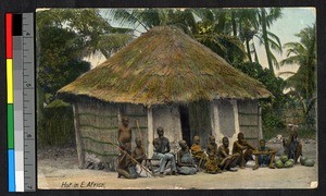 People sitting outside of a hut, German East Africa, ca.1920-1940