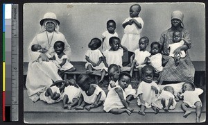 Missionary sister sitting with orphans, Yaounde, Cameroon, ca.1920-1940