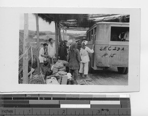 Piling baggage onto a bus at Soule, China, 1935