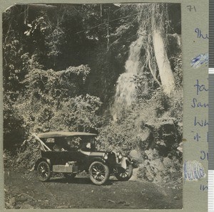 Dodge parked next to waterfall, Eastern Province, Kenya, ca.1924