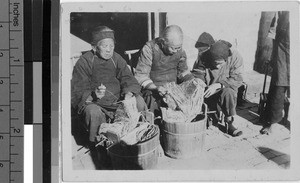 Group of elderly repairing fish nets, Yeung Kong, China, ca. 1920